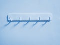 Cyan Plastic Hooks for Cloth Hanging on Cyan Wall Royalty Free Stock Photo