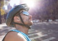 Close up of cyclist on blurry street with flares Royalty Free Stock Photo