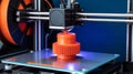 Close-up 3D printer creating red-orange gear on black build plate Royalty Free Stock Photo