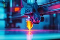 Close-up of a 3D printer nozzle creating a glowing orange object, illuminated by vibrant blue and pink lights Royalty Free Stock Photo