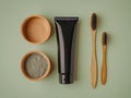 A close-up 3D render of an eco-friendly bamboo toothbrush and toothpaste tube in a black ceramic cup, alongside Royalty Free Stock Photo