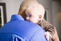 Close up of dad holding baby on shoulder