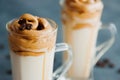 Close-up on dalgon coffee decorated with grains. Trendy cold drink with vegetable or plain milk with instant coffee sweet foam