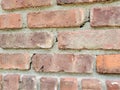 Close up of damage to red brick and mortar wall