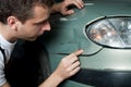 Close-up of damaged car inspected by mechanic Royalty Free Stock Photo