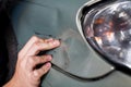 Close-up of damaged car inspected by mechanic