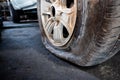 Close-up of a damaged flat tire of a car