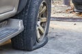 Close-up of damaged flat tire of car on parking Royalty Free Stock Photo