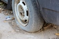 Damaged tire. The wheel of car tire leak. Flat tire waiting for repair. Abandoned car in the parking lot Royalty Free Stock Photo