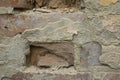 Close up of damaged wall revealing old bricks and grey plaster Royalty Free Stock Photo