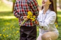 Close up of dandelions in small boy hand behind back before giving to mother. Flowers for mom. Royalty Free Stock Photo