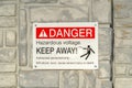 Close up of Danger Hazardous Voltage Keep Away sign posted on a gray surface