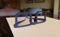 Close-up of dark blue glasses on document in office, 3D rendering