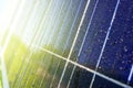 Close-up of dark blue solar panel with water drops and reflection of green trees and house Royalty Free Stock Photo