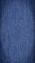 Close-up of dark blue woven surface. The texture of the material is similar to linen or denim. Abstract mobile phone wallpaper.