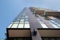 Milan, Italy, March 2020. Close up dark brown futuristic architecture of an apartment building on a background of blue sky.