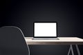 Close up of designer office desk with white mock up laptop on wooden table. 3D Rendering Royalty Free Stock Photo