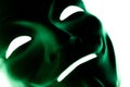 Close-up. Dark green mask isolated on white. Smile symbol of an anonymous hacker. Shooting a subject in a dark key