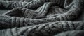 Close-Up of Dark Grey Knitted Blanket on Bed