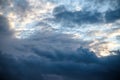 CLOSE UP: Dark grey stormy clouds gather above Lake Maggiore on a calm summer evening. Dramatic shot of clouds covering up the Royalty Free Stock Photo