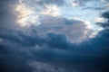 CLOSE UP: Dark grey stormy clouds gather above Lake Maggiore on a calm summer evening. Dramatic shot of clouds covering up the Royalty Free Stock Photo