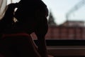 Close up dark image of thoughtful girl looking out the window during train travelling, look forward adventure. Tourist Royalty Free Stock Photo