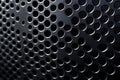 Close-up of dark metal sheet with regularly spaced circular holes Royalty Free Stock Photo