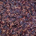 A close-up of dark purple grape pomace, a mixture of skins, seeds, and stems, left over from the winemaking process Royalty Free Stock Photo