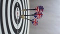 Close up of darts hitting the bulls eye on a dartboard Concept of successful business ideas hitting the exact center of