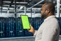 Close up of data center admin using green screen tablet in data center Royalty Free Stock Photo