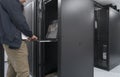 Close up on Data Center Engineer hands Using keyboard on a supercomputer Server Room Specialist Facility with Male Royalty Free Stock Photo
