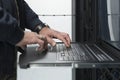 Close up on Data Center Engineer hands Using keyboard on a supercomputer Server Room Specialist Facility with Male Royalty Free Stock Photo