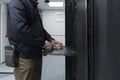 Close up on Data Center Engineer hands Using keyboard on a supercomputer Server Room Specialist Facility with Male Royalty Free Stock Photo