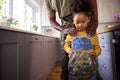 Close Up Of Daughter Holding Cap Of Army Father In Uniform Home On Leave In Family Kitchen Royalty Free Stock Photo