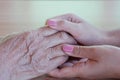 Close-up of a daughter holding her mother`s hand on Mother`s Day Royalty Free Stock Photo