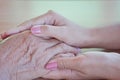 Close-up of a daughter holding her mother`s hand on Mother`s Day Royalty Free Stock Photo