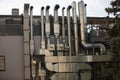 Vertical close up day shot of a bunch of restaurant kitchen stainless chimneys installed on a wall of a building Royalty Free Stock Photo