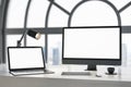 Close up of daylight designer desktop with blank white laptop computer screens, coffee cup and keyboard on wooden desktop and