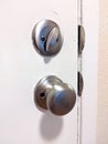 Close up of a deadbolt on the front door of a house