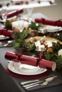Close up of decorated Christmas table setting, with centrepiece and Christmas crackers arranged on plates Royalty Free Stock Photo