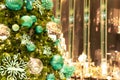 Close up decorated Christmas tree on blurred background in midnight green theme / New Year Holidays/ bokeh effect / copy space Royalty Free Stock Photo