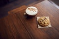 Close Up Of Decorated Coffee And Cookie On Table In Coffee Shop