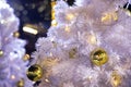Close up decorated outdoor white Christmas tree with colorful li