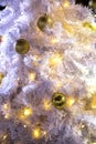 Close up decorated outdoor white Christmas tree with colorful li
