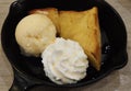 Close-up decorated shaped Bread Toast with whip cream, honey syrup and Vanilla sweet Ice Cream on black ceramic plate