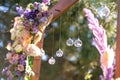 Close-up decoration with fresh flowers of venues. Wedding arch decorated with fresh flowers and hanging glass balls Royalty Free Stock Photo