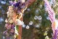 Close-up decoration with fresh flowers of venues. Wedding arch decorated with fresh flowers and hanging glass balls Royalty Free Stock Photo