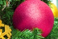 Close up decoration hanging on centre of Christmas tree branches by pink purple bauble ball Royalty Free Stock Photo