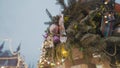 Close-up of decorations on city Christmas tree. Action. Bottom view of city Christmas tree with decorations and garland Royalty Free Stock Photo