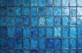 Close-up of decorative blue tile wall featuring textured squares with subtle variations in shade and glossy finish. The grout Royalty Free Stock Photo